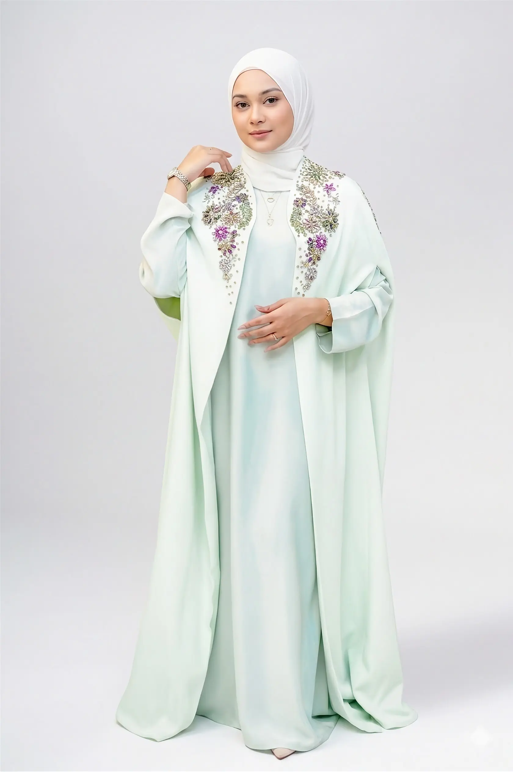 Full-length view of the Shalimar Cave Abaya in Pastel Green Barbie Crepe, showcasing the elegant flowy silhouette and matching inner slip dress from the best abaya shop in Dubai.